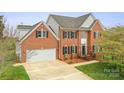 Beautiful brick two-story home with an attached garage and lush green lawn at 1919 46Th Avenue Ne Dr # 46, Hickory, NC 28601