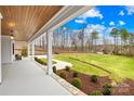 Expansive back porch offering serene views of the beautifully landscaped yard and beyond at 2010 Bessbrook Rd, Fort Mill, SC 29708