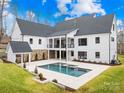 Backyard features a modern pool and spa, complemented by stone accents and lush greenery at 2010 Bessbrook Rd, Fort Mill, SC 29708
