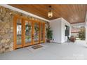 Inviting front porch with a stone accent wall, double doors, and stylish décor at 2010 Bessbrook Rd, Fort Mill, SC 29708