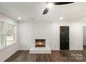 Cozy living room features fireplace, large window, and hardwood floors at 209 Palmer St, Shelby, NC 28150