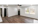 Bright living room features hardwood floors, large windows, and ceiling fan at 209 Palmer St, Shelby, NC 28150