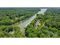 Stunning aerial view of a lakeside community with lush greenery and private docks along the tranquil waterway at 228 Wildwood Cove Dr, Mooresville, NC 28117