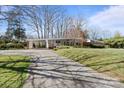 View of the front of a modern style home with a covered carport and long driveway at 2300 Cloister Dr, Charlotte, NC 28211