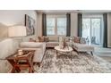 Modern living area with a neutral color palette, plush seating, and access to outdoor patio at 296 Laura Elizabeth Ln, Clover, SC 29710