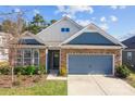 Charming home featuring a stone and siding exterior, complemented by a two-car garage and manicured landscaping at 4288 Legacy Dr, Denver, NC 28037