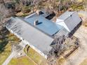 An aerial view of the home, it's gray roof, and the surrounding lush wooded landscape at 549 Briarwood Ln, Lancaster, SC 29720