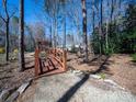 Backyard wooden bridge feature with mature landscaping in wooded area at 549 Briarwood Ln, Lancaster, SC 29720