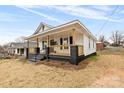 Quaint home showcasing the cozy covered porch with its natural wood posts and railing details at 612 Miller St, Kannapolis, NC 28081