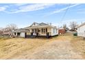 Quaint two-story home with a welcoming front porch and a simple, uncluttered landscape at 612 Miller St, Kannapolis, NC 28081