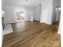 Open concept living space with hardwood floors, a decorative fireplace, and neutral walls flooded with natural light at 6440 Tivoli Ct, Charlotte, NC 28211
