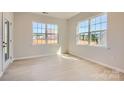 Well-lit bedroom featuring hardwood floors, neutral paint, and large windows providing natural light at 8422 Norman Forest Rd, Lancaster, SC 29720