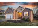 Charming brick home featuring a two-car garage and professionally landscaped front yard at 924 41St Avenue Ne Dr, Hickory, NC 28601