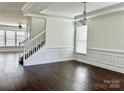 Bright living room featuring dark hardwood floors, white trim, and ample natural light at 1019 Dunhill Ln, Waxhaw, NC 28173