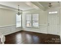 Bright living room featuring dark hardwood floors, white trim, and ample natural light at 1019 Dunhill Ln, Waxhaw, NC 28173