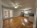 Open-concept kitchen features stainless steel appliances, granite countertops, and French doors to outside at 1116 Peachtree Rd, Charlotte, NC 28216