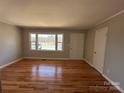 Bright living room with hardwood floors and large windows that bring in the natural sunlight at 1116 Peachtree Rd, Charlotte, NC 28216