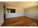 Inviting living room featuring gleaming hardwood floors and natural light, perfect for relaxing or entertaining at 1116 Peachtree Rd, Charlotte, NC 28216