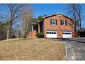 Well-maintained brick home boasts a two-car garage and a well-manicured lawn on a sunny day at 118 Sunset Dr, Chester, SC 29706