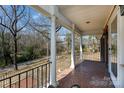 Inviting covered porch with brick flooring and white columns, offering a serene outdoor space at 118 Sunset Dr, Chester, SC 29706
