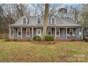 Inviting two-story home with a covered front porch, classic shutters, and well-maintained lawn at 11924 Parks Farm Ln, Charlotte, NC 28277