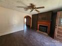 Inviting living room features decorative fireplace, archway, and wood-look flooring at 1222 Sparrow Springs Rd, Kings Mountain, NC 28086