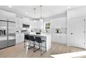 Modern kitchen with stainless steel appliances, white cabinets, and a center island with seating at 13110 Blacksmith Ct, Matthews, NC 28105