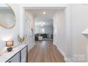 Bright entryway featuring hardwood floors, modern decor, and an open view of the living area at 147 Colonial Reserve Ave, Troutman, NC 28166