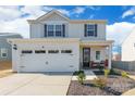 A beautiful two-story home with a welcoming porch and well-maintained landscaping at 147 Colonial Reserve Ave, Troutman, NC 28166