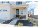 Inviting front porch with seating, decorative welcome sign, and attractive landscaping at 147 Colonial Reserve Ave, Troutman, NC 28166