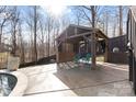 Poolside cabana featuring blue Adirondack chairs on a concrete patio with a privacy screen at 153 Byers Rd, Troutman, NC 28166