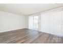 Bright living room with sliding glass door, new floors and lots of natural light at 1614 Arlyn Cir, Charlotte, NC 28213