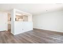 Living room view into an updated kitchen with wood-look floors at 1614 Arlyn Cir, Charlotte, NC 28213