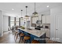 Modern kitchen features a large center island with a granite countertop and stainless steel appliances at 2302 E Main St # 1P, Albemarle, NC 28001