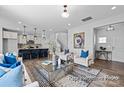 Open-concept living space with a kitchen, living room, and dining area, creating a cohesive living area at 2302 E Main St # 1P, Albemarle, NC 28001