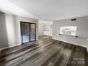 Bright and airy living room with a view of the kitchen and deck, vinyl floors, and abundant natural light at 2507 Kilborne Dr # H, Charlotte, NC 28205