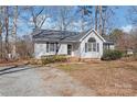 Charming single-story home featuring a well-manicured lawn, gray siding, and a classic roofline at 2913 Ashley Woods Ct, Monroe, NC 28112