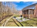 A beautiful patio with chairs and grill in the backyard, perfect for outdoor gatherings at 320 Heritage Pl, Mooresville, NC 28115