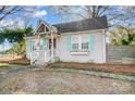 Quaint home featuring pastel blue shutters and a brick facade, adding to its curb appeal at 3800 Craig Ave, Charlotte, NC 28211