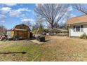 Large backyard features a storage shed, grill, carports, and ample space for outdoor activities at 400 37Th Sw St, Hickory, NC 28602