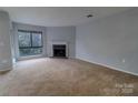 Comfortable living room with a fireplace and large windows for natural light at 4814 Spring Lake E Dr, Charlotte, NC 28212
