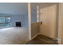 Inviting living room with a cozy fireplace and bright natural light at 4814 Spring Lake E Dr, Charlotte, NC 28212