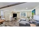 Spacious living room with a comfortable gray sectional, modern flooring, and natural light at 5304 Split Oak Dr, Charlotte, NC 28227
