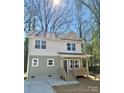 Charming two-story home featuring a cozy front porch, neutral siding, and well-manicured front yard at 613 Granite Ave, Gastonia, NC 28052