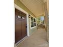 Inviting covered front porch with wood decking, providing a charming entryway to the home at 613 Granite Ave, Gastonia, NC 28052