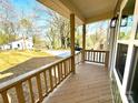 Spacious covered front porch with wood railings, offering a relaxing outdoor space at 613 Granite Ave, Gastonia, NC 28052