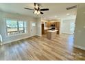 Open-concept living area flowing into the kitchen, featuring stylish wood-look flooring at 613 Granite Ave, Gastonia, NC 28052