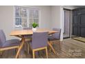 Inviting dining room featuring a modern table set, wood floors, and a front door view at 825 21St Ne Ave, Hickory, NC 28601