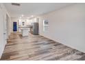 Open-concept living area showcasing durable wood flooring and recessed lighting at 834 N Flint St, Lincolnton, NC 28092