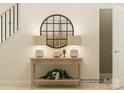 Inviting entryway with a stylish table, lamps, decorative mirror, and staircase at 8421 Norman Forest Rd, Lancaster, SC 29720